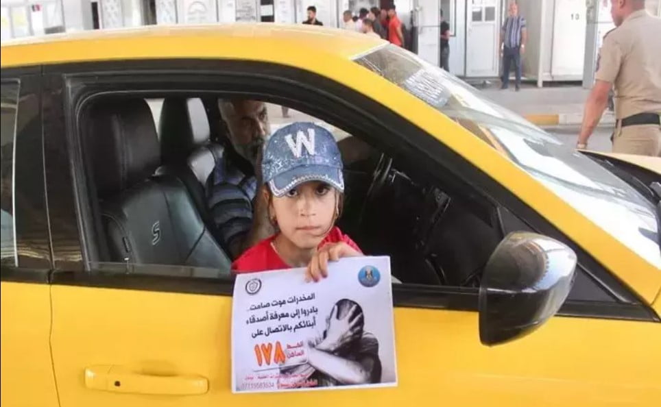 An Iraqi girl holds a sign that warns of the dangers of drugs on May 19 as part of an awareness campaign carried out by Iraqi forces in conjunction with their efforts to take down regional and international drug smuggling networks.