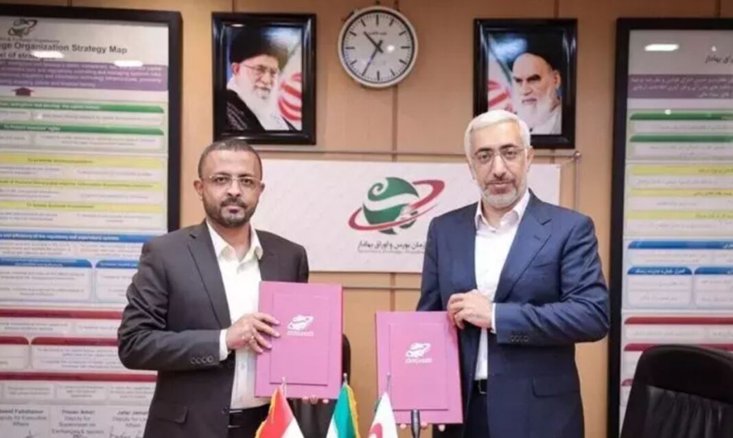 Securities and Exchange Organisation of Iran head Majid Eshqi and Hashim Ismail, governor of the Houthi-controlled Central Bank in Sanaa, display an agreement they signed for the exchange of information on the development of securities markets and stock exchange activities.