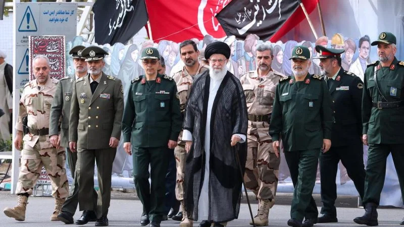 The IRGC commanders walk with Ali Khamenei.