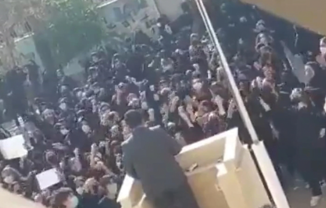 Screengrab from unverified film shows Iranian students waving their headscarves and chanting 'get out' at a member of the IRGC.