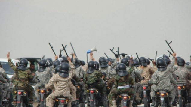 Iranian IRGC Basij militia members rally as they head towards protesters.